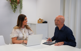 Een medewerker bespreekt samen met een inwoner een vraag over geldzaken.